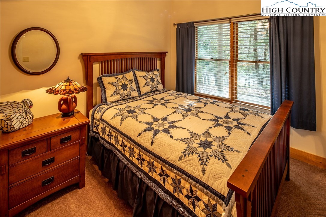 1278 Meadow Road Ferguson, NC 28624 - Photo 22 of 38 a bed sitting in a bedroom next to a window