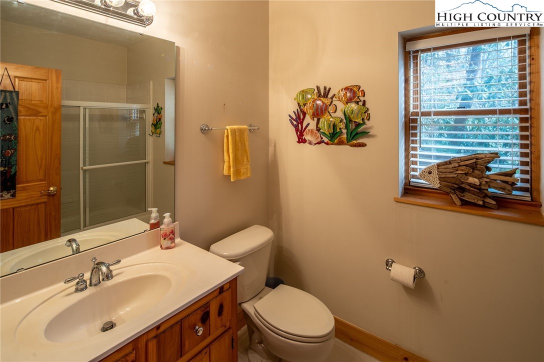1278 Meadow Road Ferguson, NC 28624 - Photo 23 of 38 a bathroom with a sink mirror and toilet