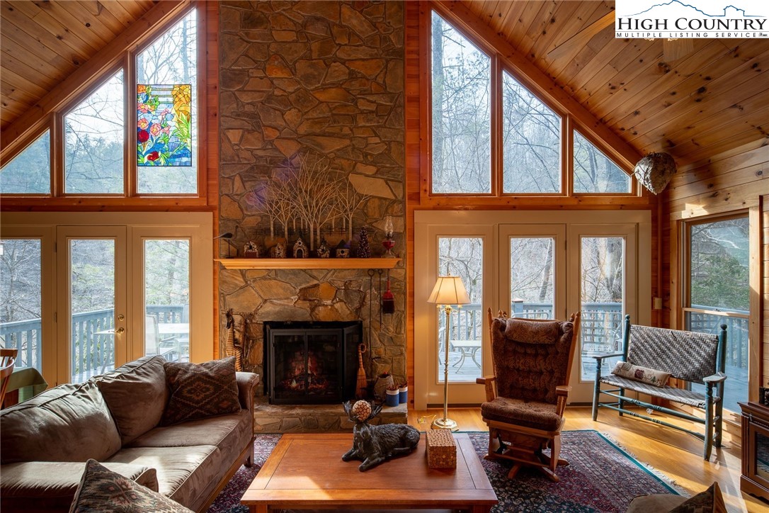 1278 Meadow Road Ferguson, NC 28624 - Photo 5 of 38 a living room with furniture a fireplace and a large window