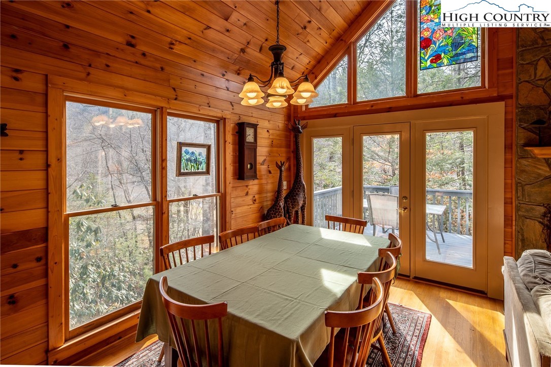 1278 Meadow Road Ferguson, NC 28624 - Photo 7 of 38 a dining room with furniture a chandelier and wooden floor