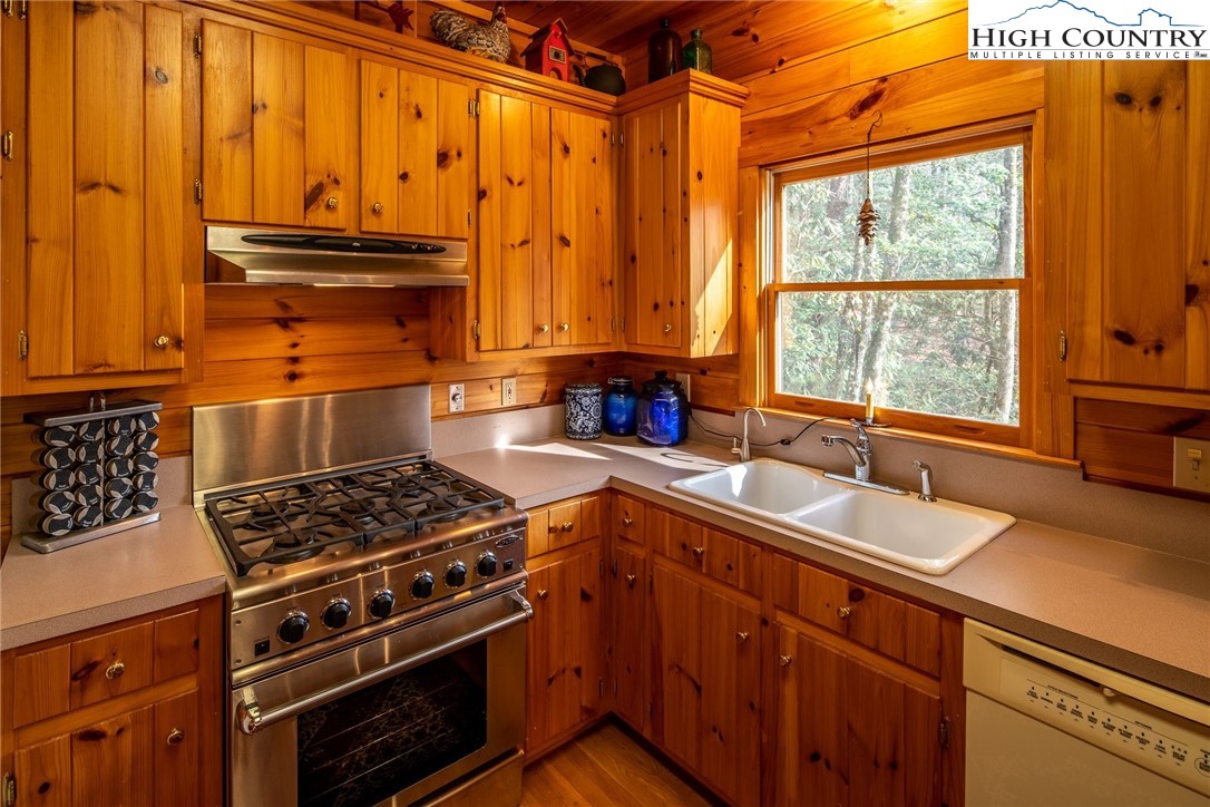 1278 Meadow Road Ferguson, NC 28624 - Photo 10 of 38 a kitchen with stainless steel appliances a stove sink and cabinets