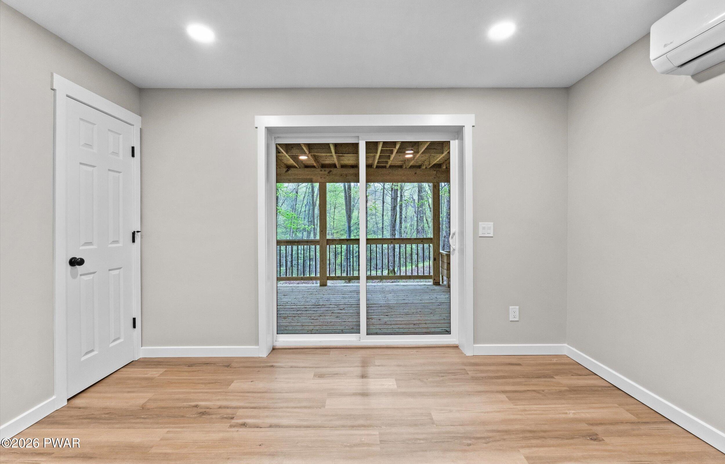 9 High Point Court Lake Ariel, PA 18436 - Photo 26 of 40 a view of an empty room with wooden floor and a window