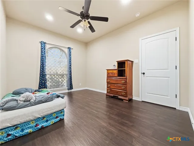 a bedroom with furniture and wooden floor