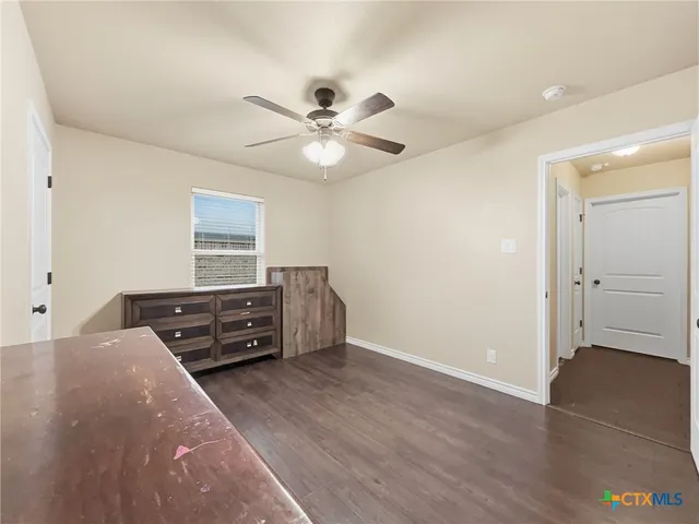 a room with a dresser and a window