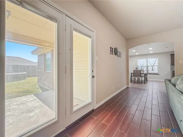 a view of a hallway view with wooden floor and staircase