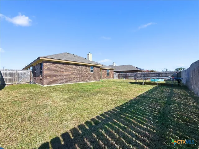 a view of a swimming pool with a yard