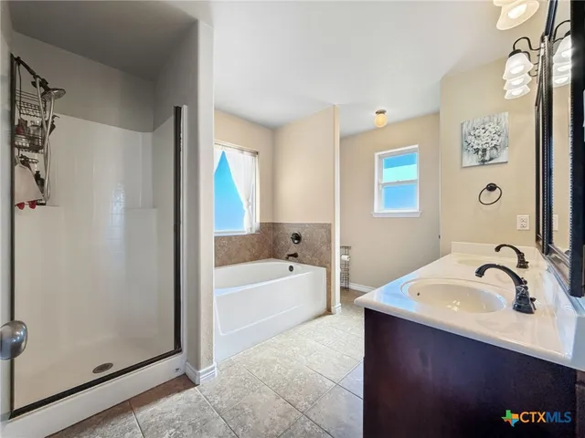 a bathroom with a tub sink and mirror
