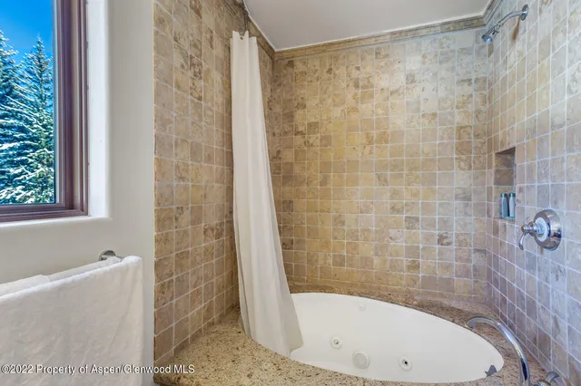 a bathroom with a bathtub and shower