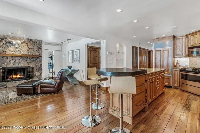 a kitchen with stainless steel appliances granite countertop a stove and a refrigerator
