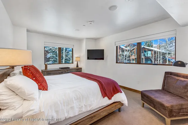 a bedroom with a bed couch and window