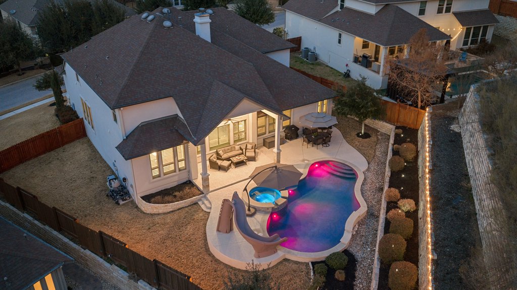 5812 Davenport Divide Road Austin, TX 78738 - Photo 2 of 40 A private backyard retreat designed for long summer afternoons, poolside lounging, and relaxed evenings under the covered patio.