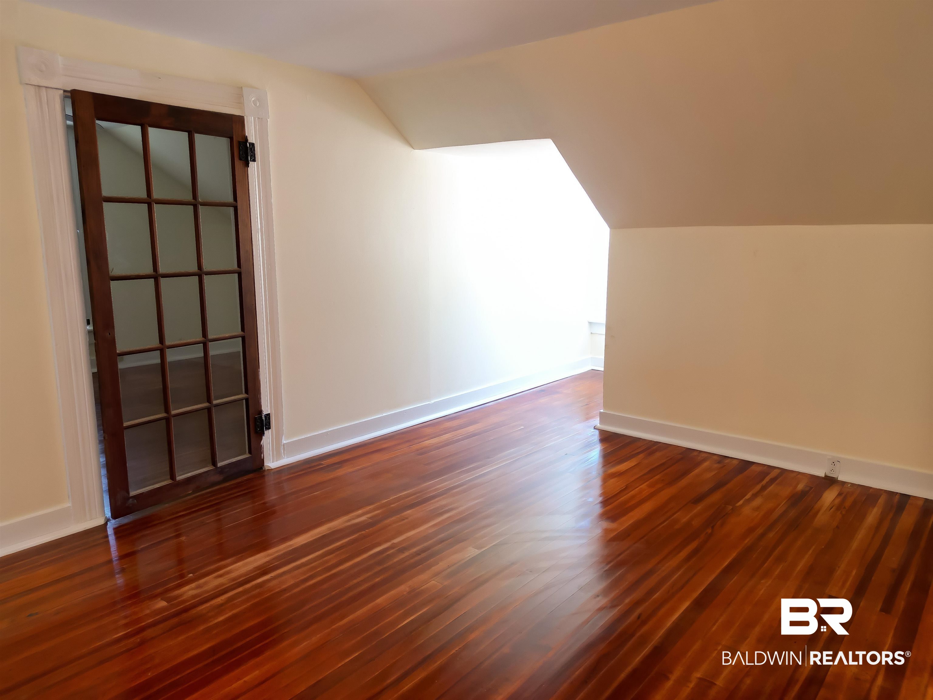 73 Liberty Street Monroeville, AL 36460 - Photo 23 of 29 Additional living space with dark wood-type flooring and vaulted ceiling