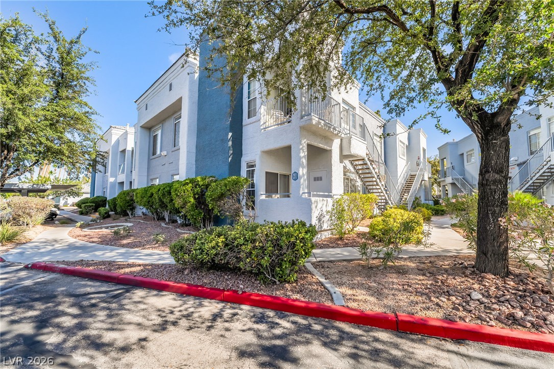 2201 Ramsgate Drive, Unit 811 Henderson, NV 89074 - Photo 31 of 36 A community of contemporary residences featuring well-maintained landscaping and accessible outdoor staircases.