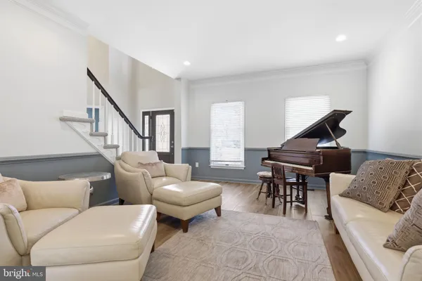 a living room with furniture and a piano