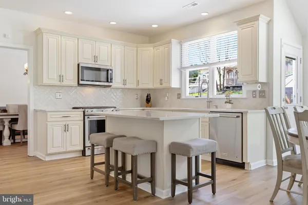 a kitchen with a white stove top oven sink and cabinets