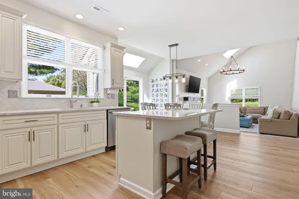 a kitchen with stainless steel appliances a stove microwave and cabinets