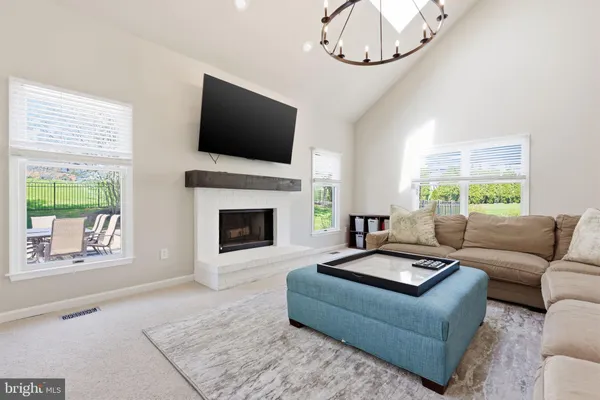 a living room with furniture a rug and a flat screen tv