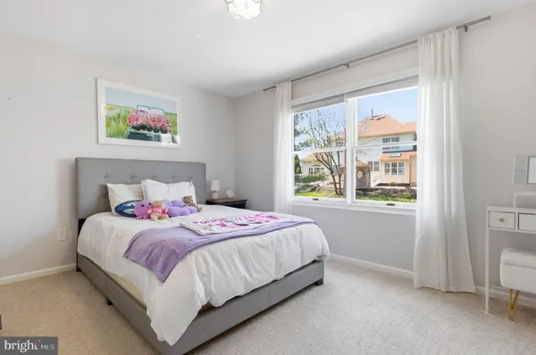 a bedroom with two beds and a large window