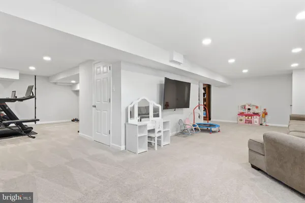 a room with gym equipment and a flat screen tv
