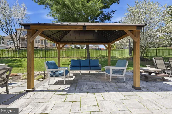 a view of patio with table and chairs under an umbrella