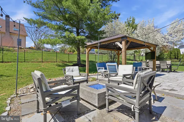 a view of a patio with a table chairs and a floor to ceiling window