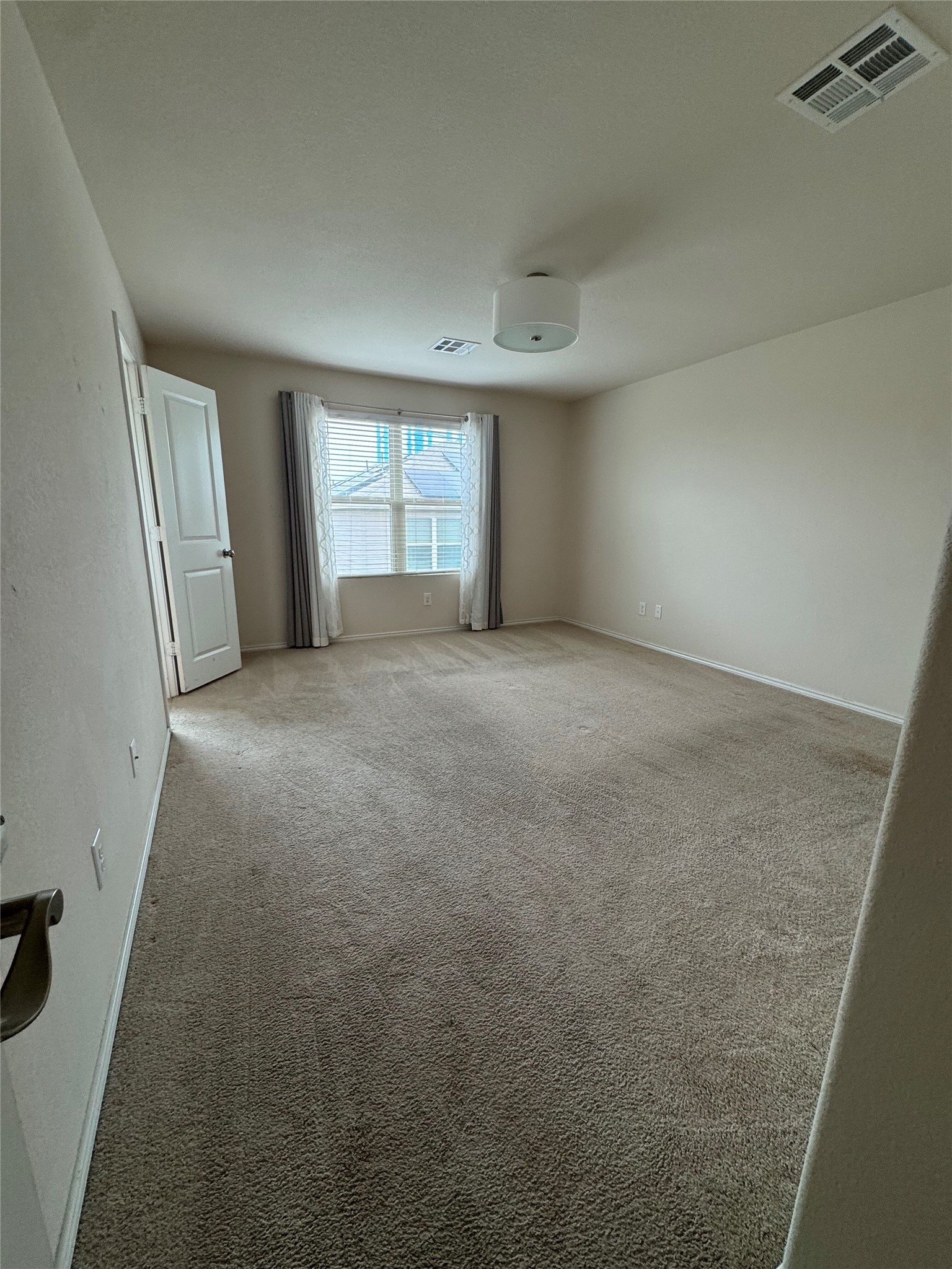 1108 Jackson Lane, Unit 5B Jarrell, TX 76537 - Photo 10 of 29 Spare room featuring light colored carpet and baseboards