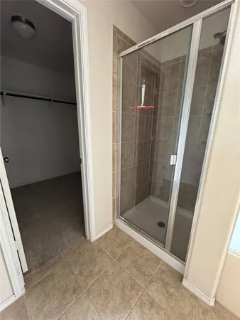 an empty room with wooden floor and closet