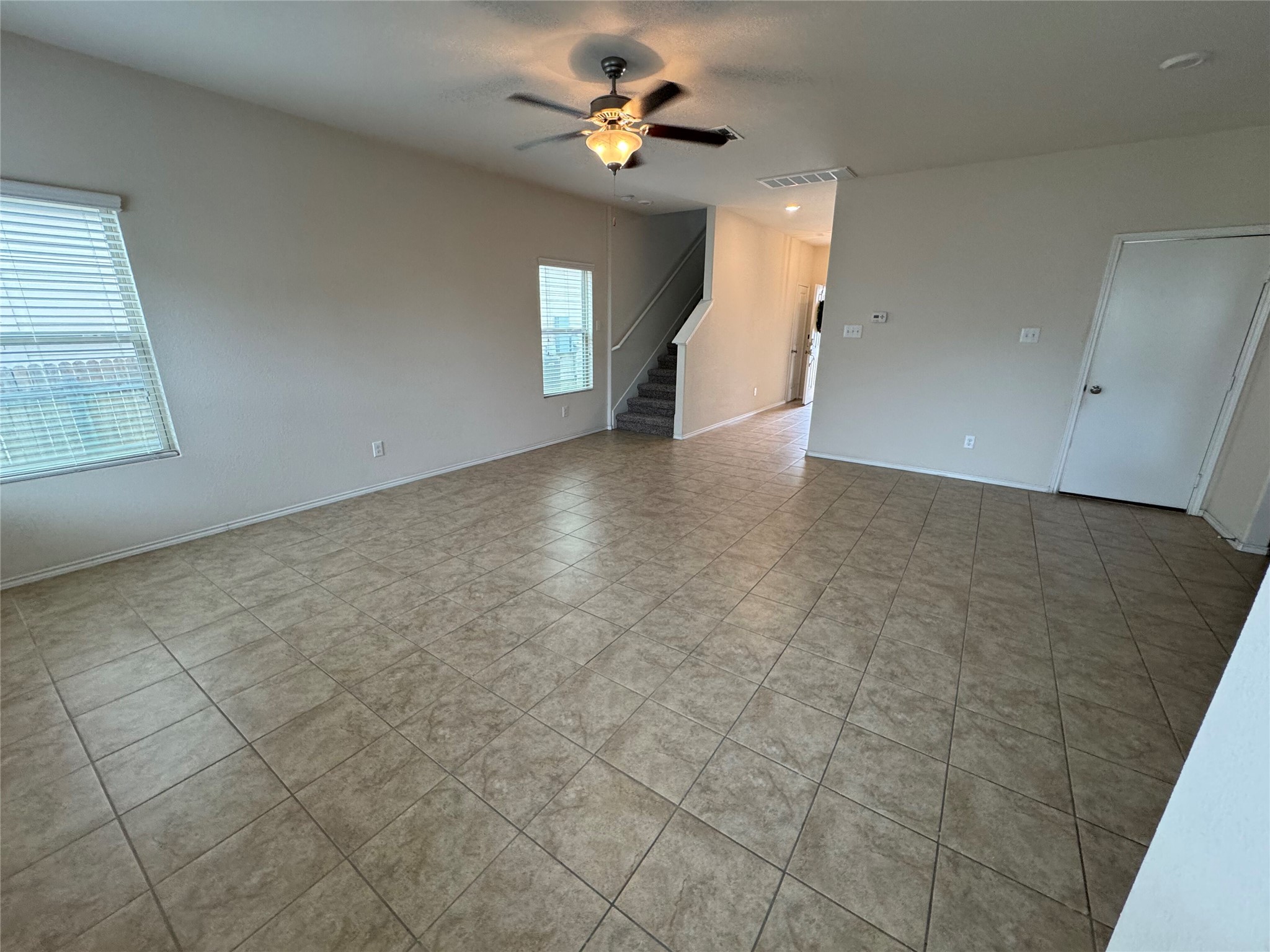 1108 Jackson Lane, Unit 5B Jarrell, TX 76537 - Photo 23 of 29 Empty room with a ceiling fan and light tile patterned floors