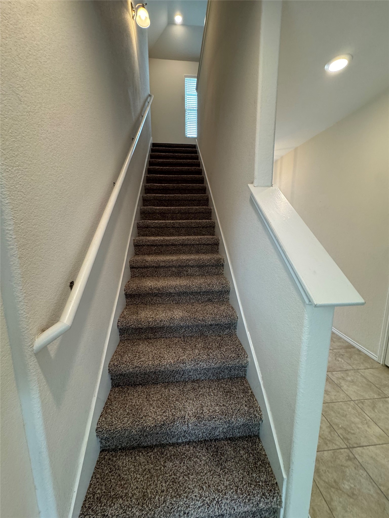 1108 Jackson Lane, Unit 5B Jarrell, TX 76537 - Photo 25 of 29 Stairs with tile patterned floors and a textured wall