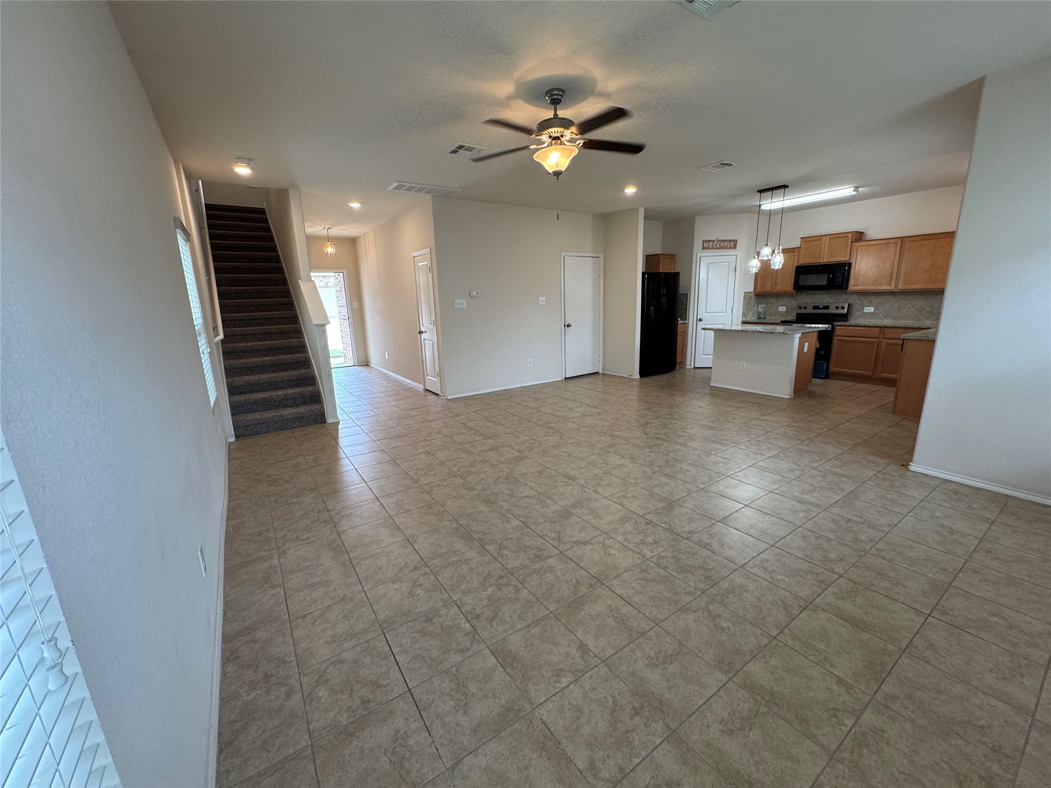 1108 Jackson Lane, Unit 5B Jarrell, TX 76537 - Photo 26 of 29 Unfurnished living room featuring a ceiling fan and light tile patterned floors