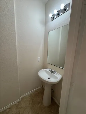 a bathroom with a sink a mirror and a toilet