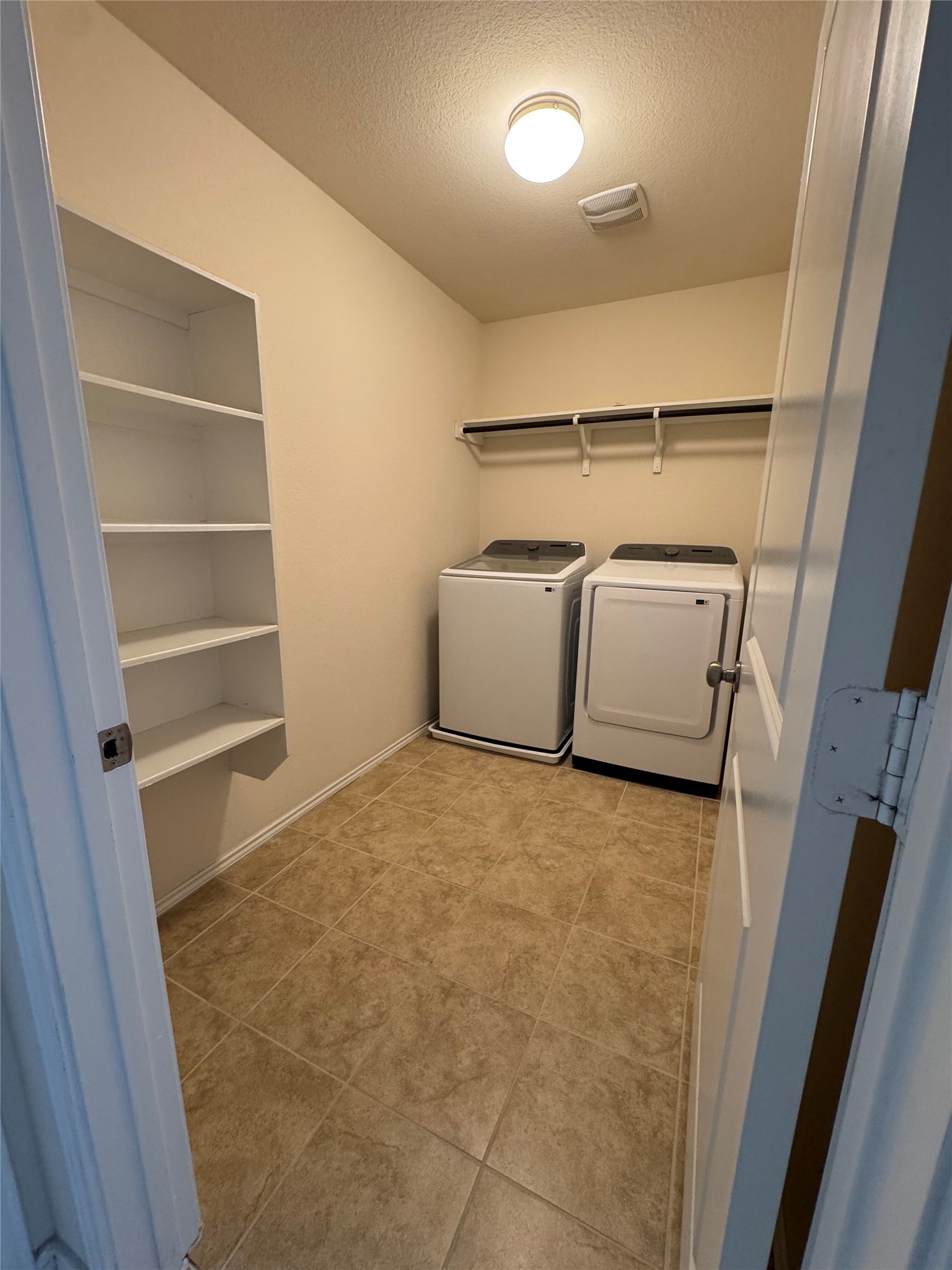 1108 Jackson Lane, Unit 5B Jarrell, TX 76537 - Photo 8 of 29 Laundry area with a textured ceiling and washer and dryer