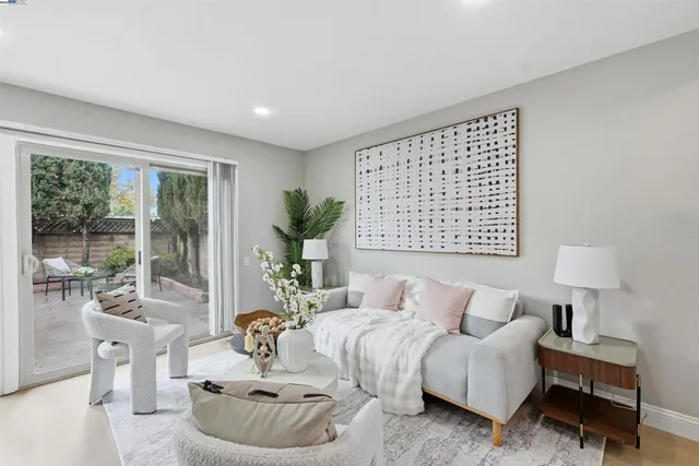 a bedroom with furniture and a large window