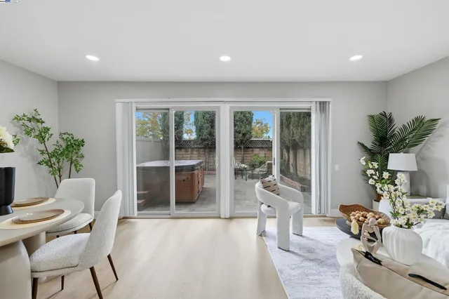 a living room with furniture and potted plants