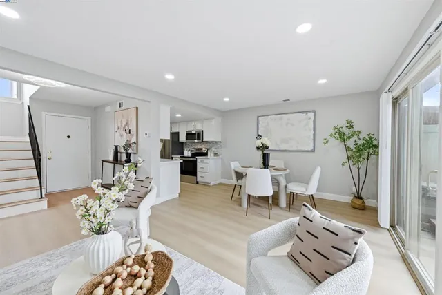 a living room with furniture and flowers