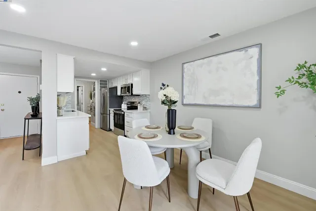a view of a dining room with furniture and wooden floor