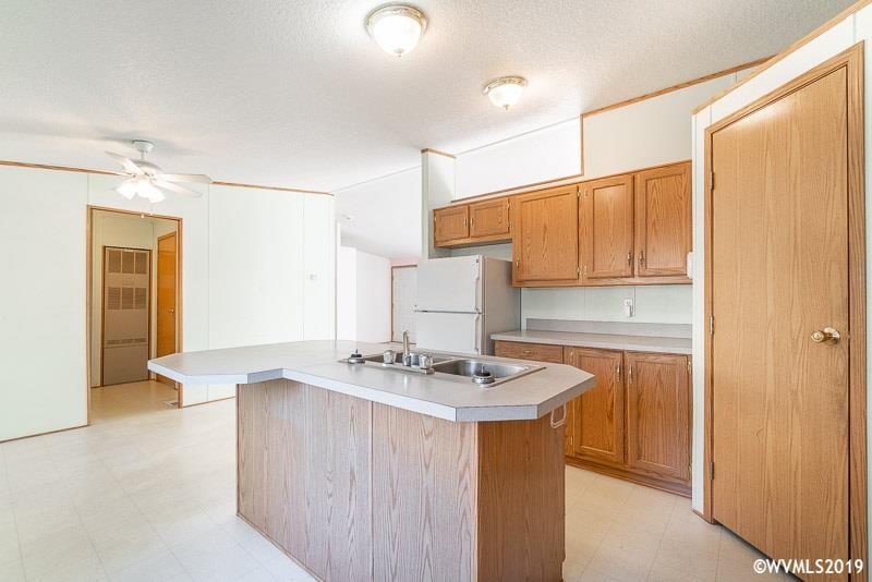 775 Hoffman Road Northeast, Unit 4 Salem, OR 97301 - Photo 15 of 23 a kitchen with stainless steel appliances granite countertop a sink a stove and refrigerator