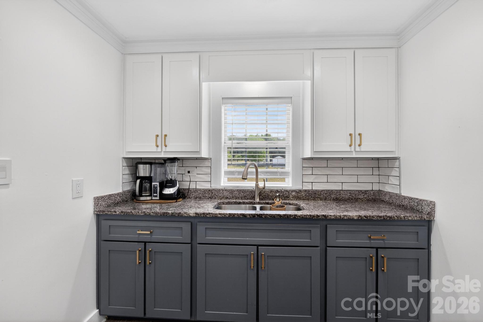 2076 Connelly Springs Road Lenoir, NC 28645 - Photo 14 of 47 a kitchen with stainless steel appliances granite countertop a sink and a white cabinets