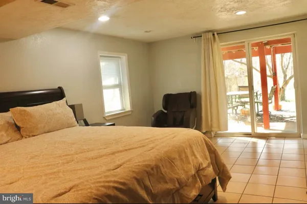 a large bed sitting in a bedroom next to a window