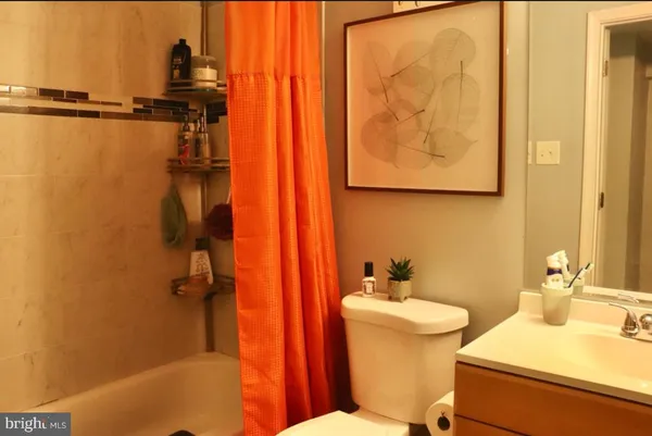 a bathroom with a sink mirror vanity and toilet