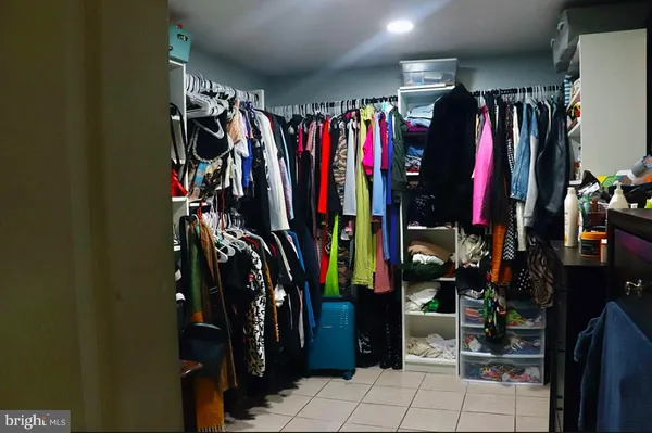 a view of walk in closet with clothes