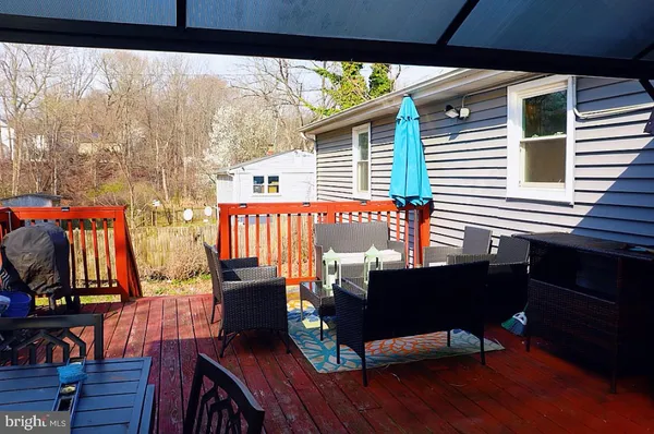 a view of a balcony with chairs and wooden floor