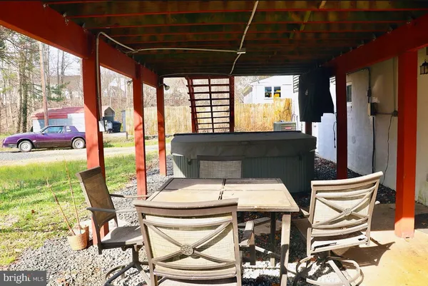 a view of an outdoor dining space with a table and chairs