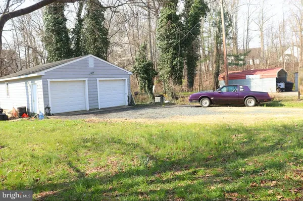 a view of a house with a yard and garage