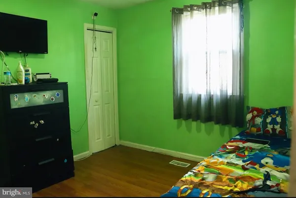 a view of a room with floor to ceiling window and a flat screen tv