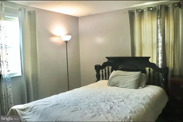 a bedroom with a bed and a mirror