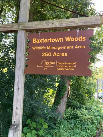 a view of a backyard with a small cabin and wooden fence