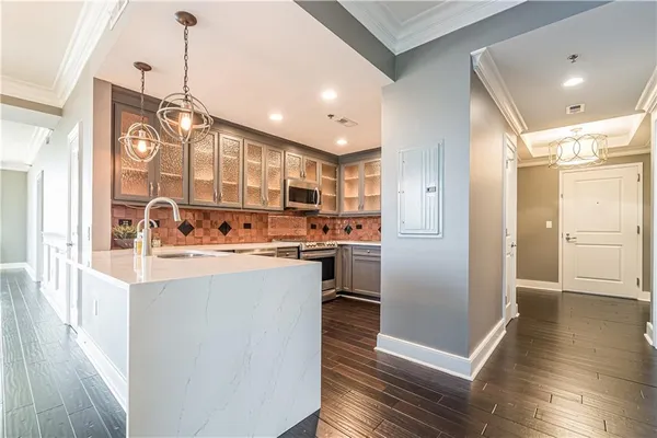 a kitchen with refrigerator cabinets and wooden floor