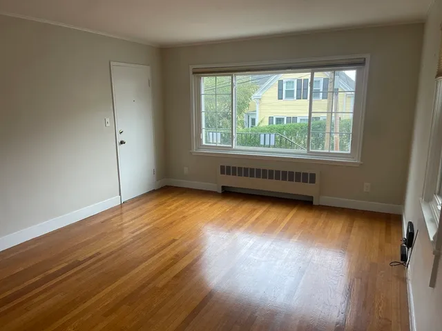 a view of room with window and hardwood floor