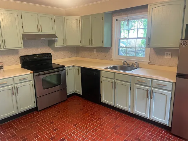 a kitchen with a sink stove and cabinets